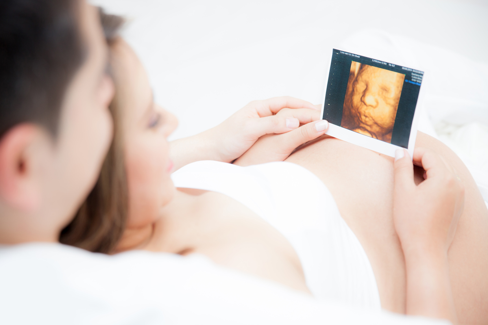 Happy parents looking at the last ultrasound